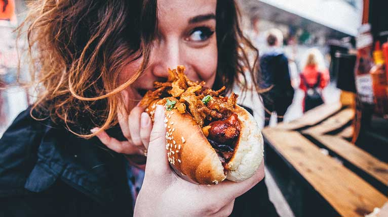 Girl eating hotdog